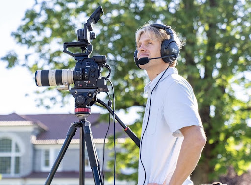 Ocean Lakes graduate Cameron Houck smiles while shooting a video of an event at James Madison University.