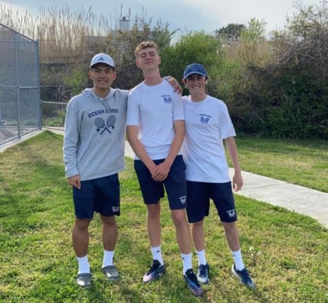 Vincent Yi, Philip Dewitz and Gabe Holmes embrace after winning a match at Kempsville High School on April 3, 2023.