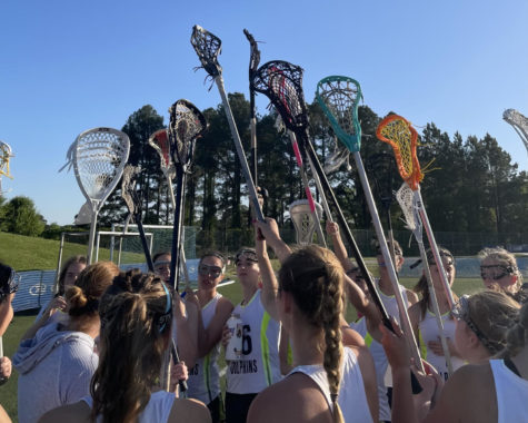 Girls lacrosse celebrates their win against Salem High School on April 19, 2023, at the Virginia Beach Sportsplex.