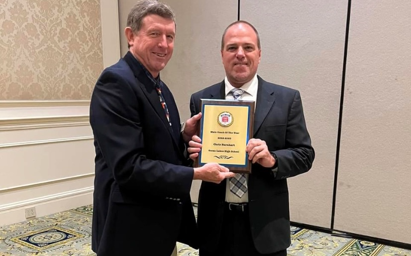 Christopher Barnhart and Mike Ware stand together after awarding Barnhart with the “Coach of the Year Award” at the Virginia Beach Sports Clubs annual Jamboree on May 31, 2023.