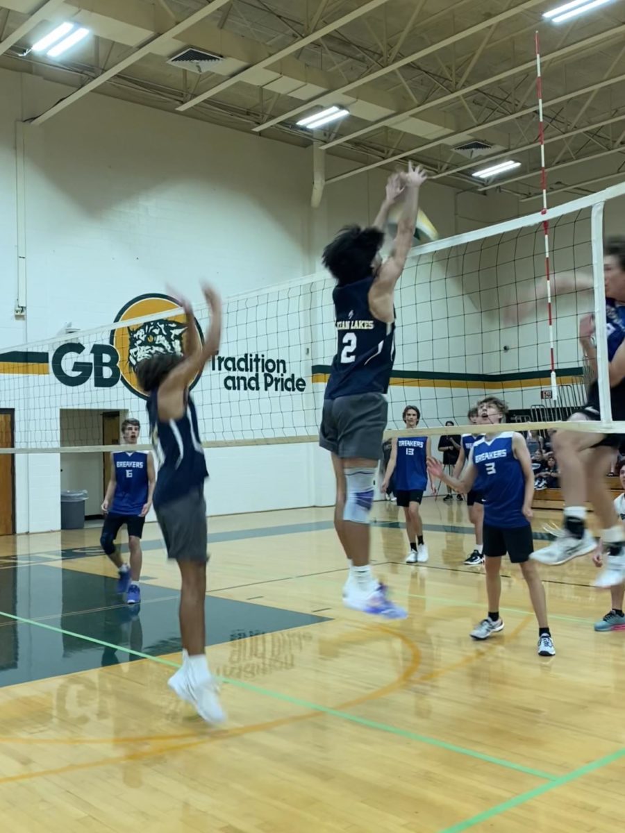 Donny Velazquez blocks an opponents spike against the Beach Breakers, a home school team, at Great Bridge High School on Aug. 18, 2023.