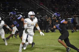 Elijah Goldsmith blocks Landstowns defensive player from reaching the ball during a run play at Landstown High School on Aug. 24, 2023. 