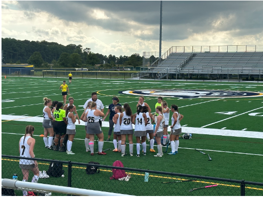 Girls field hockey huddles up during their game at Ocean Lakes against Oscar Smith on Aug. 29, 2023. Photo used with permission from Missy Dunaway.