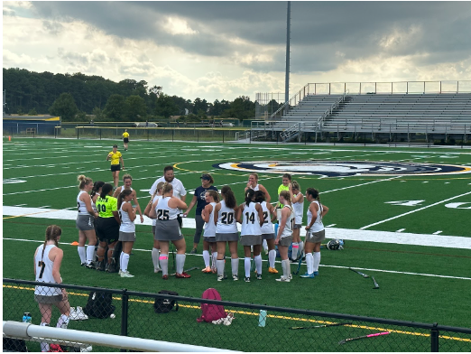 Girl's field hockey huddles up during their game at Ocean Lakes against Oscar Smith on Aug. 29, 2023. Photo used with permission from Missy Dunaway.