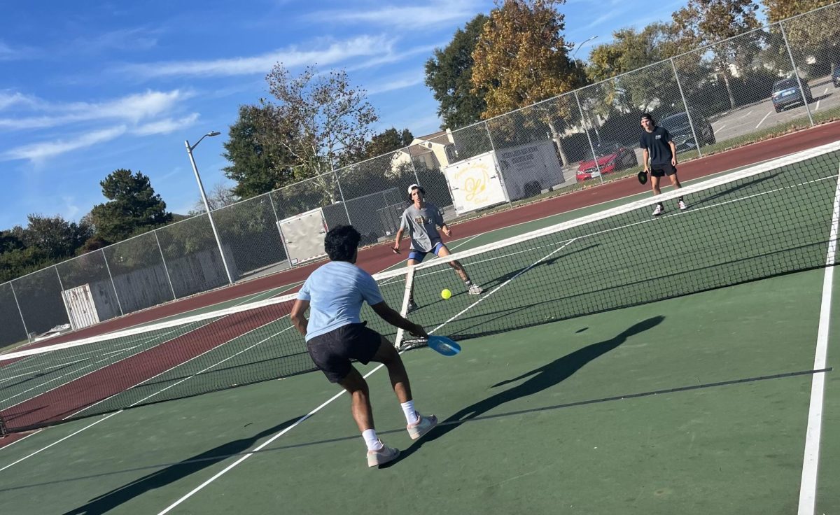 (from left) Revanth Renukunta hits a volley as Kaden Pratt and Inti OBrien prepare to return his shot on Oct. 18, 2023. All three have been involved members of Pickleball Club. 