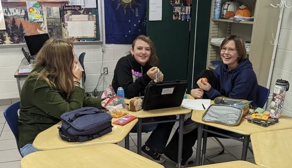 Club members Molly Nybo, Cory Duncan and Taylor Martinez share and critique their spooky short stories in Room 144 during One Lunch on Nov. 2, 2023. Photo used with permission from David Carney.