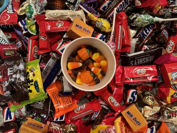 A bowl of candy corn rests on an assortment of Halloween candy on Oct. 31, 2023.