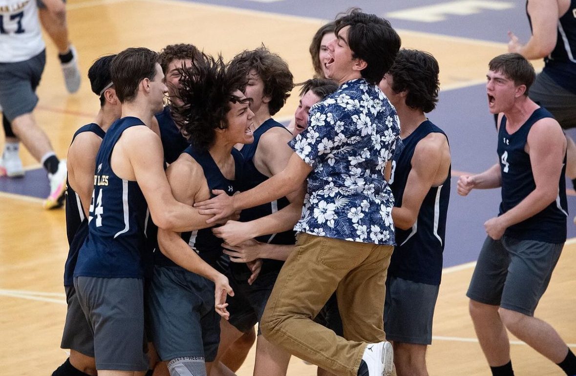 Boys volleyball players jump and hug one another in excitement, seconds after the referee blew the final whistle. Picture taken during the regional final against Kempsville on Nov. 7, 2023 at Deep Creek High School.