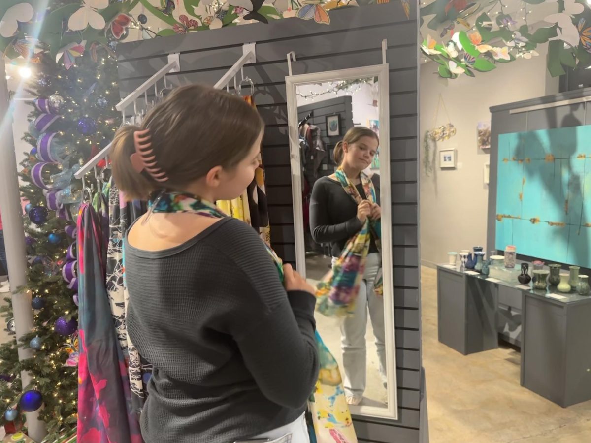 Sophomore Brooke McCallister hunts for the perfect Christmas gift at the Virginia Beach Art Center on Nov. 29, 2023. There, she browsed the many hand crafted gift displays in the winter showcase.