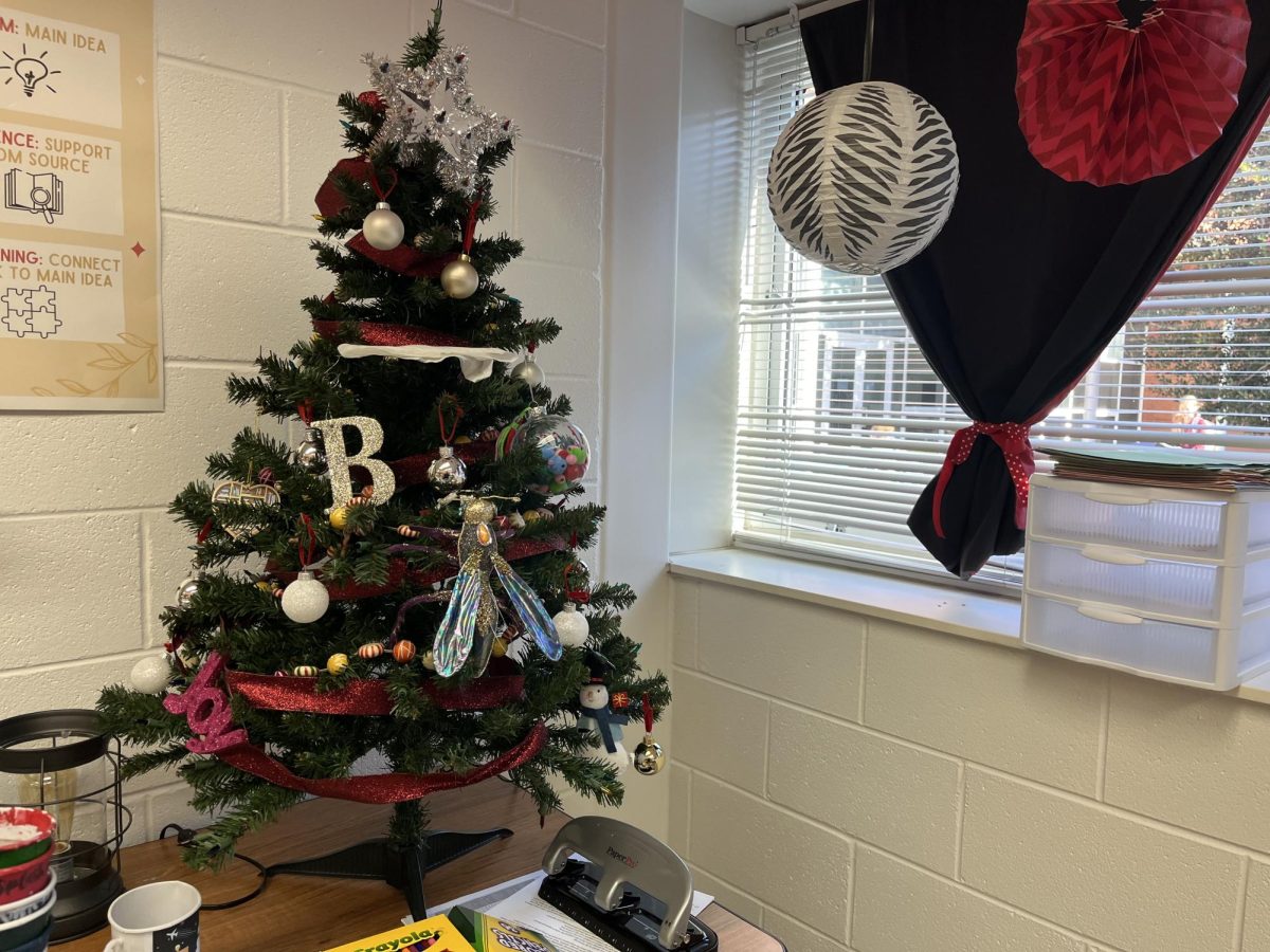 Ornaments sit on a mini Christmas tree in AP Lang teacher Kristi Bayers classroom in Room 126. Christmas decorations represent another relatively cheap gift suitable for anyone. 