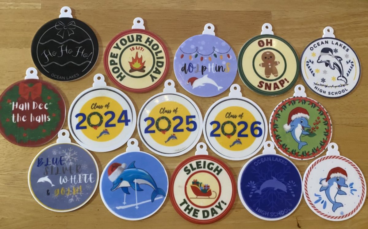 A group of finished ornaments sits on a table in Room 126 on Dec. 7, 2023. The stickers were designed by freshmen and were printed by Rebecca Strohm and her students, a real-world work experience for them. Photo used with permission from Kristi Bayer.