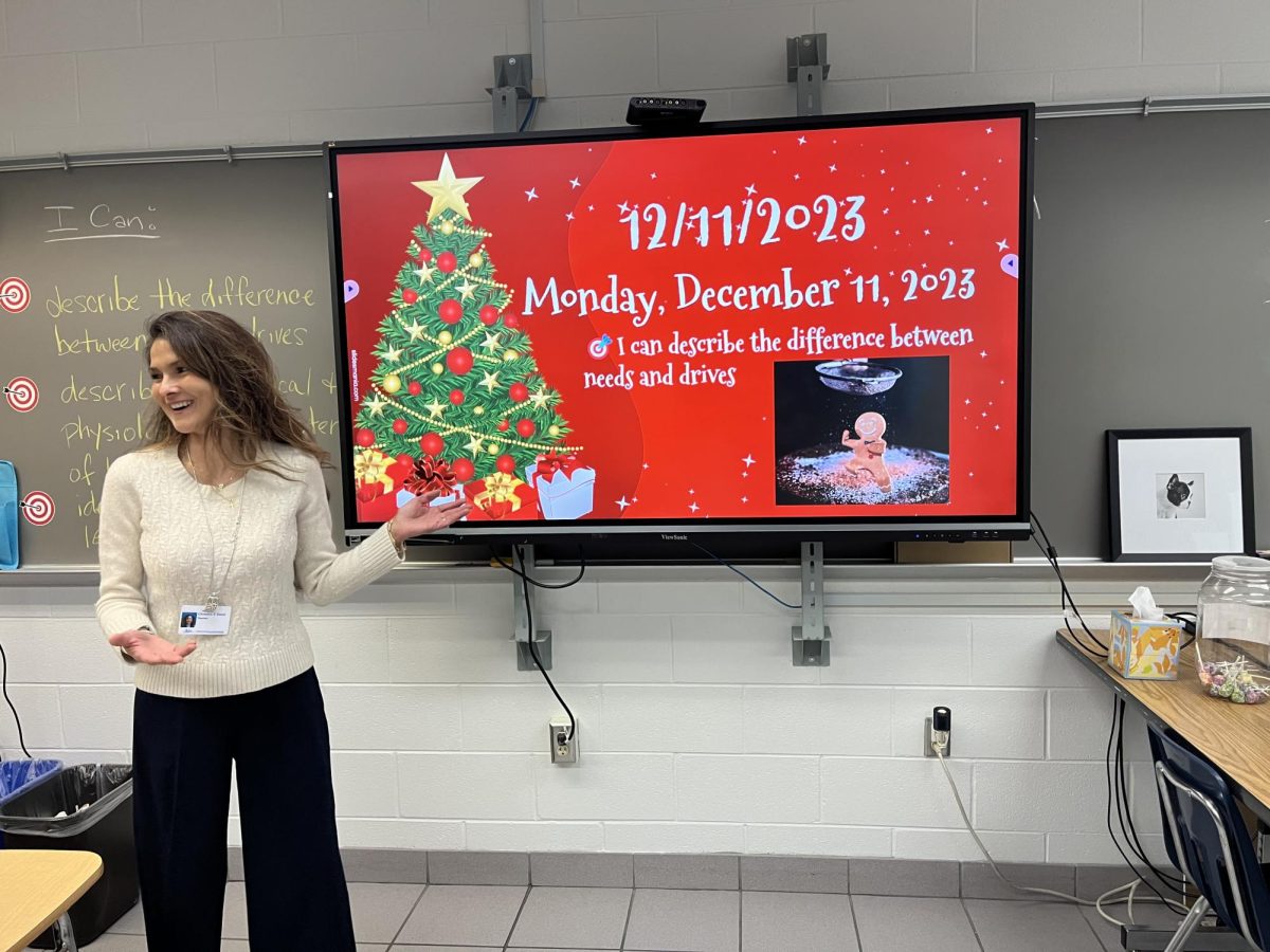 Christine Steed starts psychology class with the day’s learning target on a festively themed slideshow during third block in Room 152 on Dec. 11, 2023.
