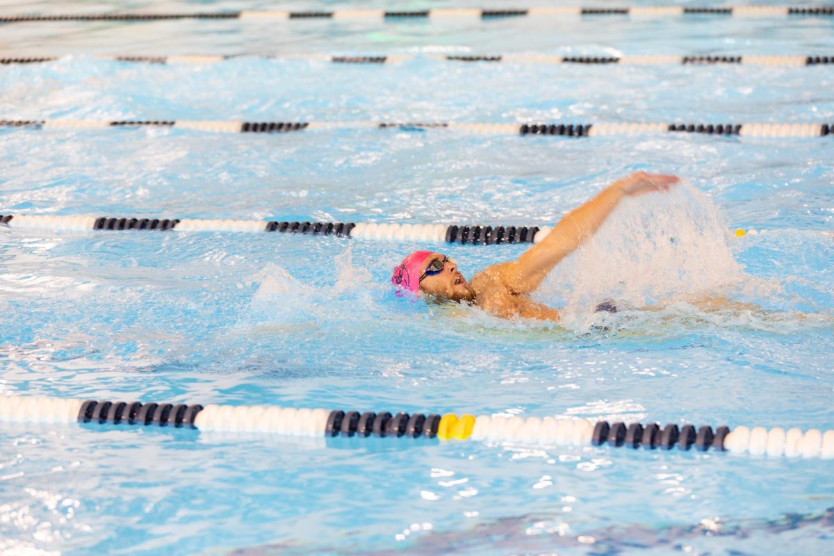 Senior Sam Lindsey performs backstroke in a race against First Colonial on Dec. 1, 2023, at the Princess Anne Recreation Center. Photo used with permission from David Bostic. 