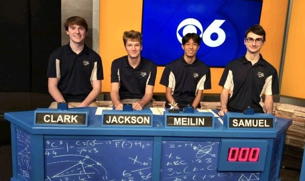 Members of the Scholastic Bowl team sit at their stations before the start of round two of Battle of the Brains on Jan. 17, 2024. From left to right: sophomore Clark Smith, junior Jackson Crickard, senior and captain Meilin Ranjan and senior Samuel Kidd. Photo used with permission from Miranda Blaser.
