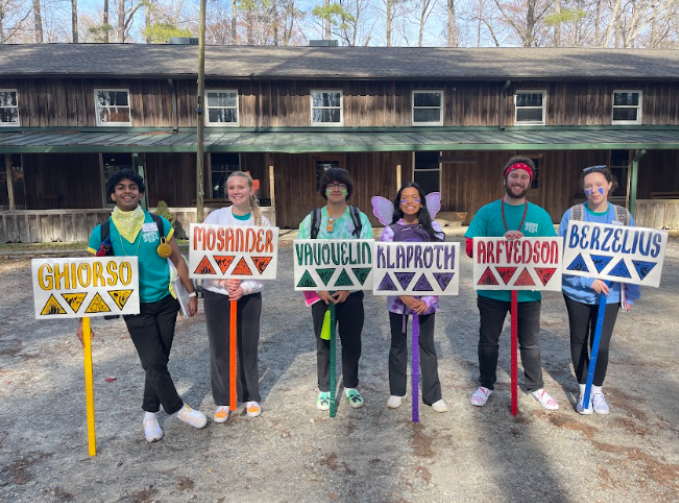 From left: seniors and counselors Revanth Renukunta, Anna Kain-Kuzniewski, Jesse Gutierrez, Julianna Angeles, Alex Panecaldo, and Molly Ryan Gates hold their council signs to guide delegates on March 9, 2024. Photo used with permission from Christina Barnhart.