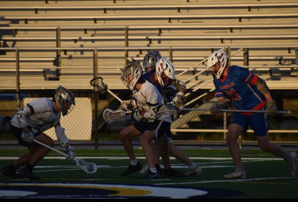 Junior Shawn Madsen and senior Luke Ruble claim the ball against Kempsville at Ocean Lakes High School on April 12, 2024. Photo used with permission from Jade McAboy. 
