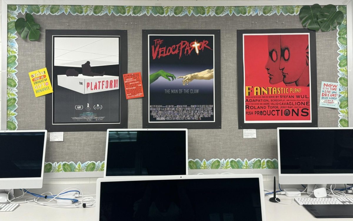 Movie posters created by digital art students hang on the wall in the digital art classroom on March 29, 2024.