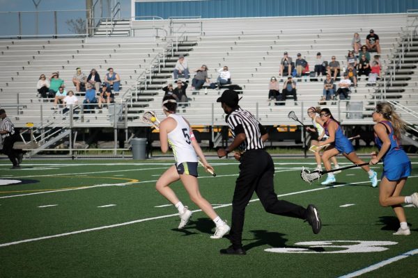 Molly Ryan Gates runs down the field with the ball in her stick at the Kempsville vs. Ocean Lakes game on April 12, 2024, at Ocean Lakes High School. 
