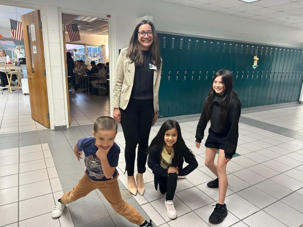 Administrative assistant Jessica Pagan brought her three children to school on National Take Your Daughters and Sons to Work Day on April 25, 2024.  Pictured here is the four of them in the English hallway. 