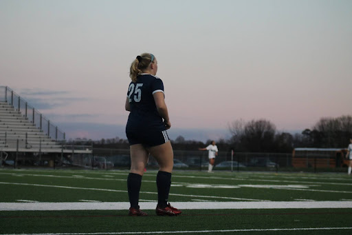 Senior Allison Orchard-Hayes scans the field after passing the ball to her teammate on March 7, 2024, at Ocean Lakes High School in a scrimmage against Hickory High School.
