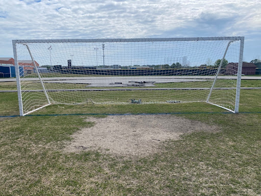A pile of dirt on the grass field in the center of the track covers the soccer goal box on April 10, 2024.
