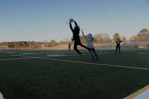Brady Smith catches a lofted pass from Drew Davidson on Feb. 2, 2024, at the First Colonial football field. Brady’s training with track helped him use his speed and agility to get open on this rep. 
Photo used with permission from Justin Smith.