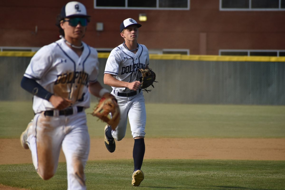 Sophomore Connor Mais and senior Jack Marchesi run to their home dugout as the inning switches at Ocean Lakes high school on May. 16, 2024, at their final home game of the season against the Landstown Eagles. 