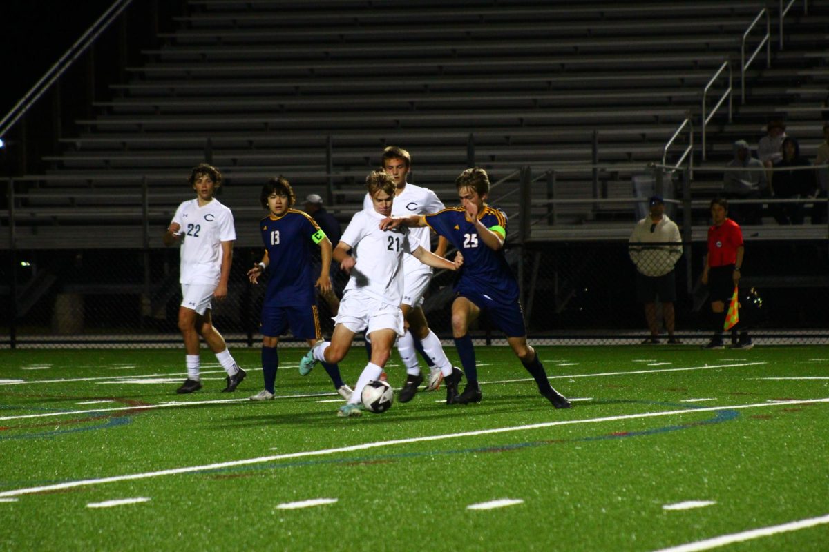 Canon Robins halts the forward attack of the Cox Falcons and attempts to make a clearance during a match at home April 16, 2024. The Dolphins rely heavily on a strong backline this season that is led by Robins. 