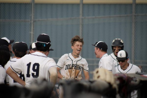 Senior Jack Marchesi celebrates his home run against Floyd E. Kellam High School with his teammates after touching home plate. With the home run, Jack brought in three runs on May 7, 2024, at Ocean Lakes High School. 