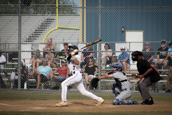 Sophomore Connor Mais looks for the ball after he swings at a pitch from the Kempsville Chiefs at Ocean Lakes High School on April 30, 2024. The Dolphins finished with a 6-2 victory.
