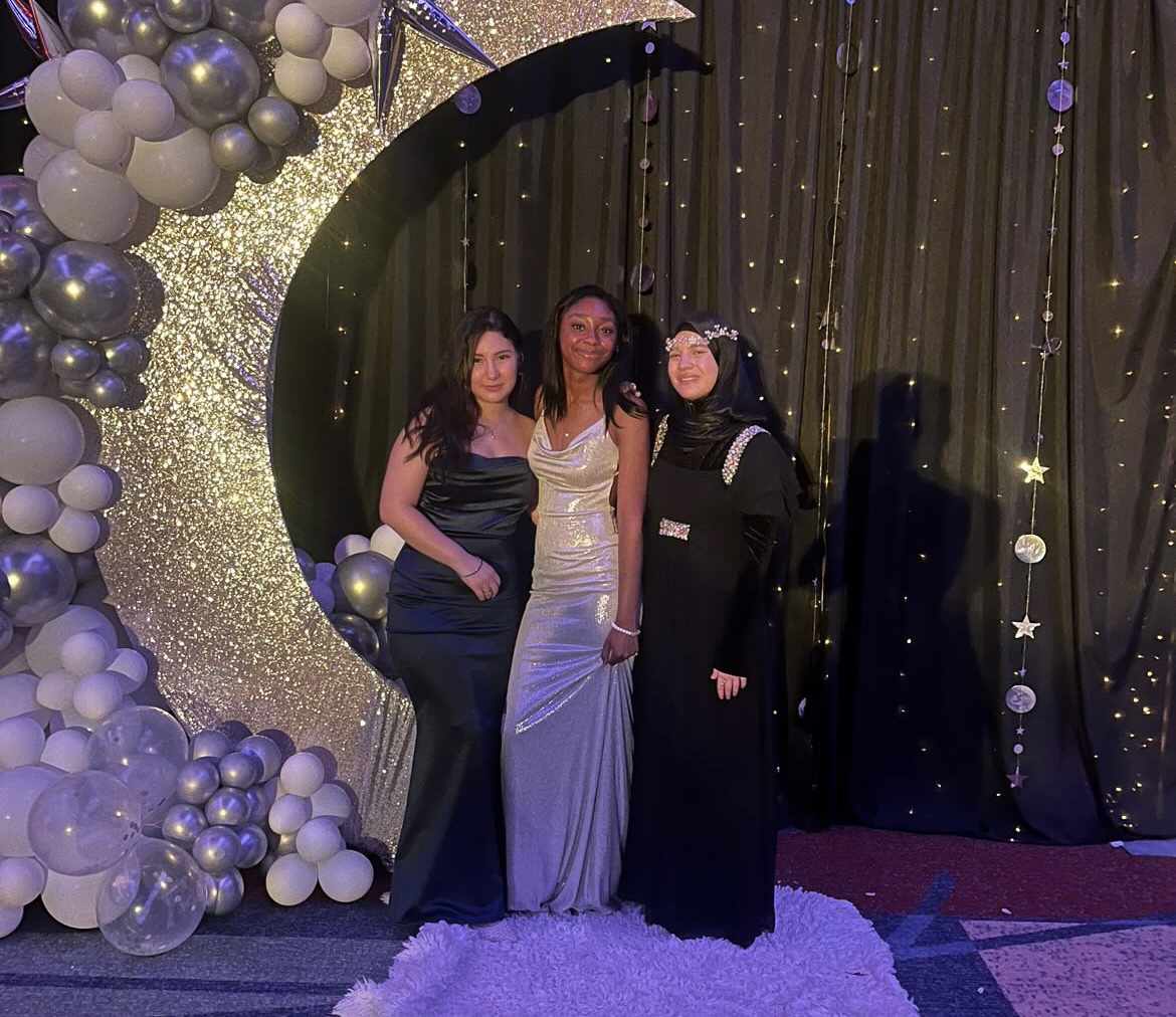 From left to right: seniors Vanessa De La Cruz, Toni G Hill and Reyhan Akkale immerse themselves in the midnight magic of prom held at the Virginia Beach Convention Center on June 8, 2024. The decorations, prepared by English teachers and class sponsors Thomas Stewart and Shelby Wyatt, added to the magical night. Photo used with permission from Jayden Egan.