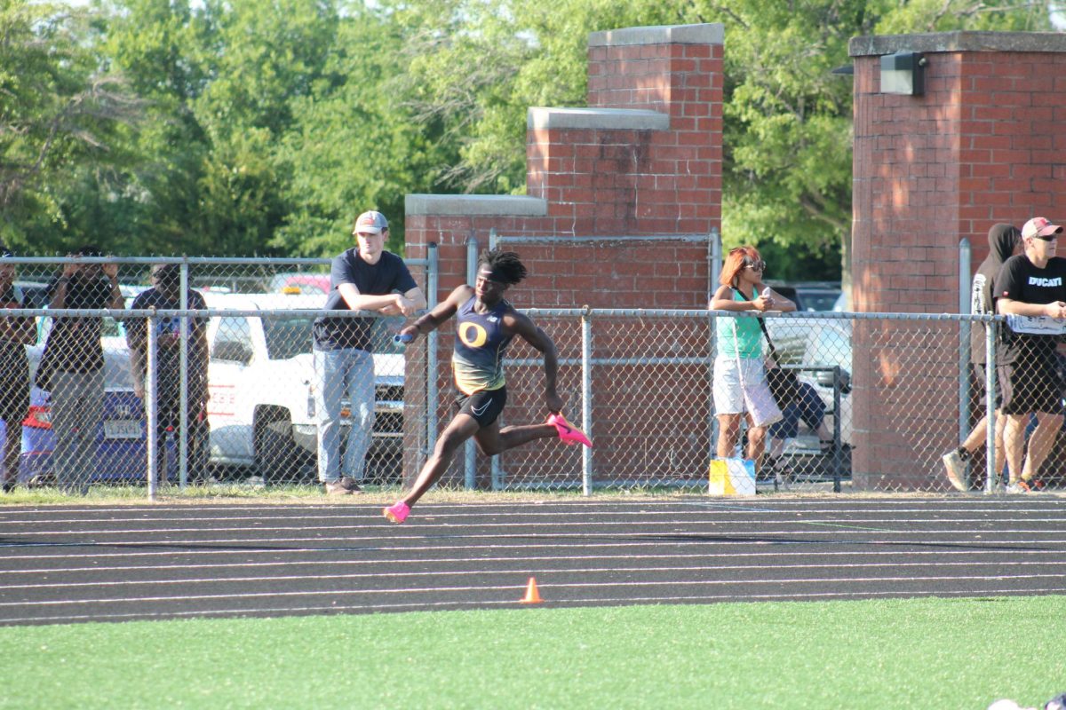 Senior Madison Monroe runs the curve of the track as he races in the 4x100 as the first leg at regionals. The team placed second on May 22, 2024, at Salem High School.