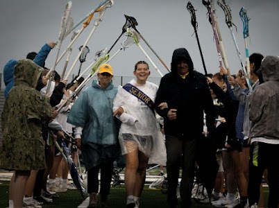 Senior Melanie Dunaway walks alongside Danny and Missy Dunaway at the senior night celebration on May 14, 2024, at Ocean Lakes High School. Melanie is a two year varsity starter and will attend James Madison University after graduation.