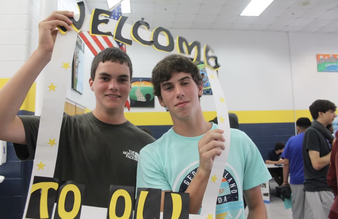 Freshmen Cormac Worrall and Fenton Million smile in the cafeteria on August 22, 2024. They had the chance to find out about the clubs and activities offered at Ocean Lakes.