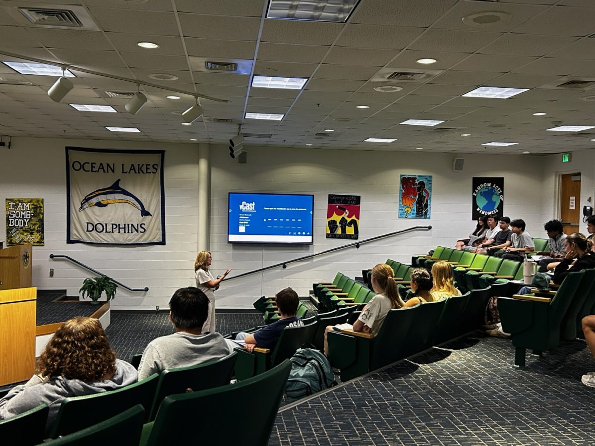 A College representative from Brown University speaks to the students in the schola on Sept. 27, 2024. The students are eager to learn more about what she has to say about the university.  
