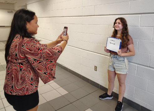 Gillian Gutierrez takes a headshot of Callie Haroun for fall play auditions on Sept. 11, 2024, outside the cafeteria. The OLTC requires students to take headshots before their auditions.