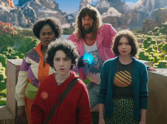 The four human protagonists (from left to right: Danielle Brooks, Sebastian Hansen, Jason Momoa and Emma Myers) stand together with the Minecraft landscape behind them. Photo courtesy of Warner Brothers.