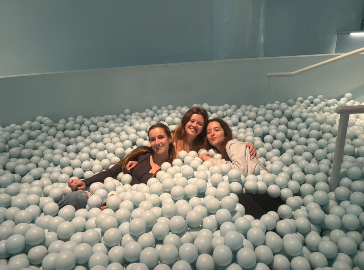 Seniors Kayley Urick, Lilian Bond and Madison Hewitt visit the signature ball pit at the Color Museum on April 13, 2023. The Color Factory offers an interactive experience with colorful displays of artwork and activities. Photo used with permission from Madison Hewitt.