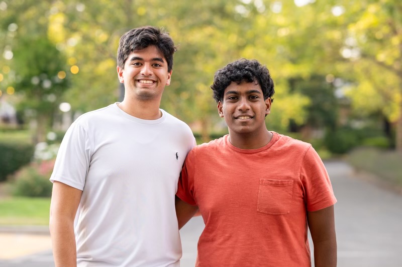 Ayush Jain, left, and Aniketh Kolla smile near the YCombinator headquarters in Calfornia on July 13, 2024. Jain, the Class of 2022 valedictorian, and Kolla co-founded Syntra, a medical AI company. Photo used with permission from Ayush Jain.