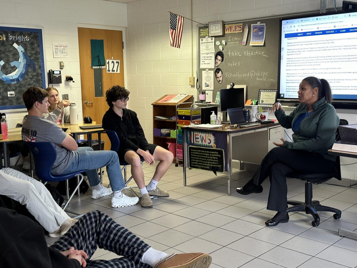 School board member Jessica Owens speaks with students in Fara Wiles’ class about the new cellphone policy in Room 127 on Nov. 22, 2024. She visited Ocean Lakes as part of the school board's efforts to gather input from students. Pictured, from left to right: Ryne Bracknell, Chloe Purvis, Isaiah Omier, Jessica Owens. 