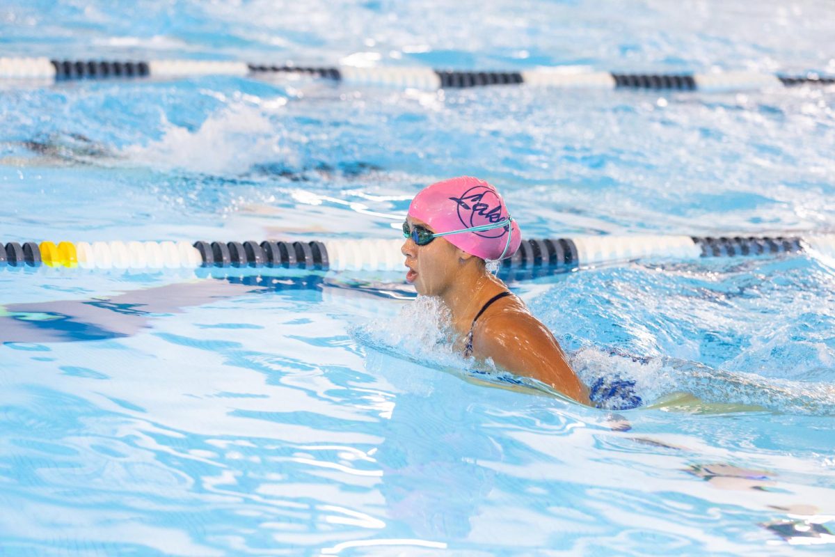 Senior Sofia Thompson competes the breaststroke at the District Swim Championships on Feb. 4, 2024. Sofia swims for TIDE and Ocean Lakes Swim Team. Photo used with permission from David Bostic.  

