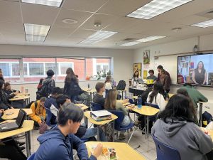 From left to right, Mia Ordonez, Joshua Ng, Justin Salvador and Brie Gesick present a video to the club on Nov. 21, 2024 in Room 132. The video covered the common Thanksgiving traditions of Asian countries.
