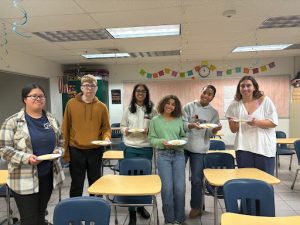 From left to right: Juniors Sherlene Song, John Rank and Aditi Ramasamy and seniors Khadija Sissoko, Sofia Thompson and Rania Jacob meet together in Room 244 for Cultural Appreciation Club on Dec. 18, 2024. They made cookies, played with dreidels and learned about Hannakuah.
