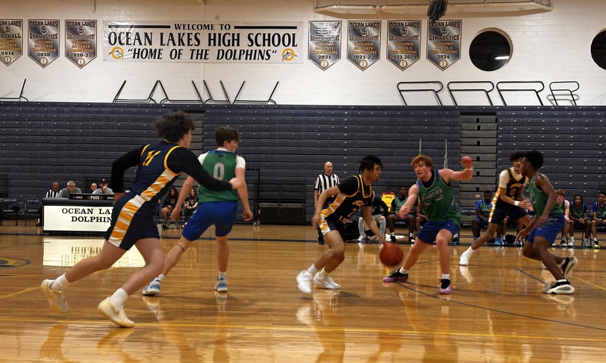 During the Ocean Lakes vs. Atlantic Shores scrimmage on Nov. 19, 2024, junior Treyvon Green stole the ball and drove to the basket, with seniors Chase Mullen and Nash Phillips following closely behind during a fast break play
