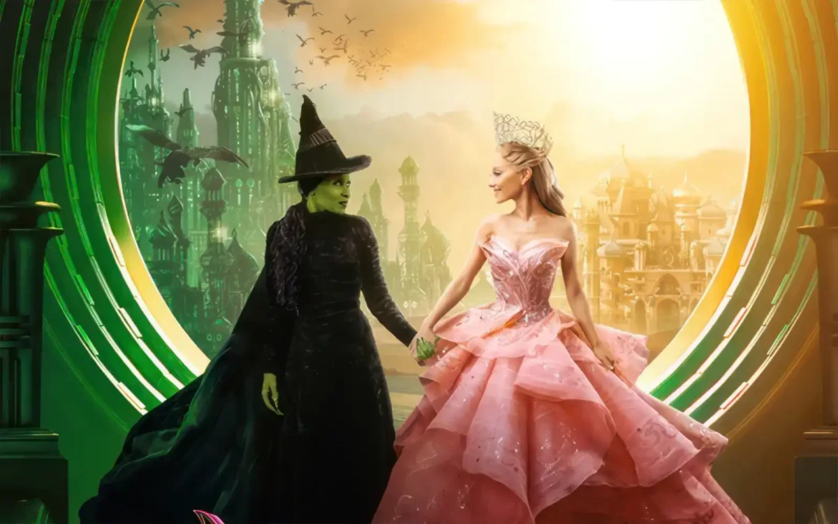 From left to right: Elphaba (Cynthia Erivo) and Galinda (Ariana Grande) hold hands as they stand in front of The Emerald City and Shiz University. “Wicked” has currently earned over $400 million in the box office, making it one of the highest earning movies in 2024. (Fly solo or join forces? Workplace lesson from 'Wicked'/ FMT/ CC BY-SA 4.0) 