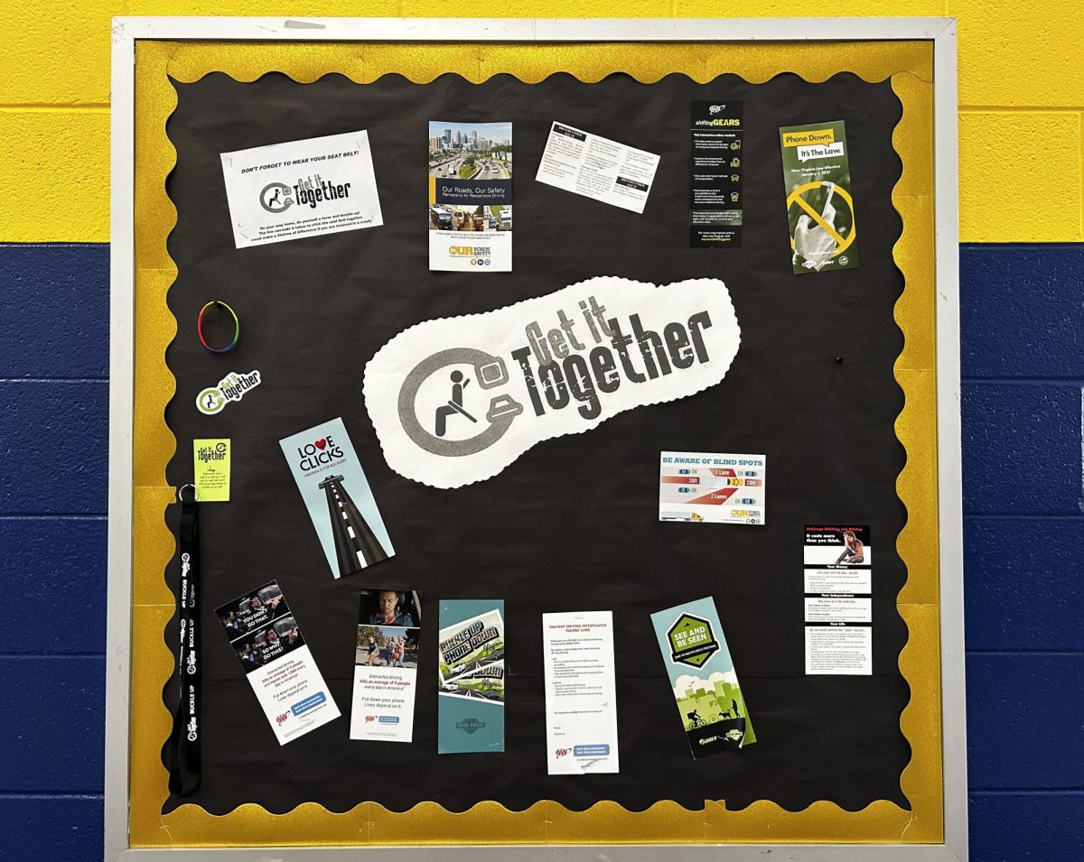 Bulletin board in the cafeteria promotes  the Get it Together Seat Belt Challenge challenge with merchandise and promotional pamphlets on Jan. 17, 2024. The board was constructed by assistant principal James Imbriale and driver education teacher Michael Pollock.