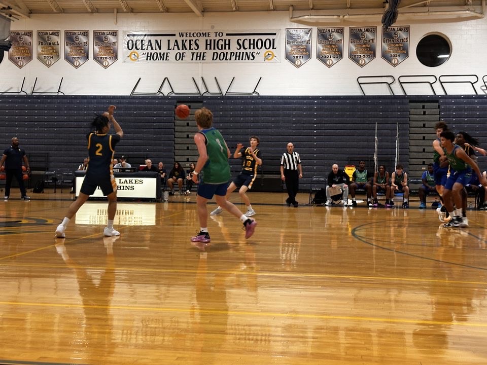 Junior Treyvon Green throws a fast pass towards sophomore Avery Gentry during their scrimmage against Great Bridge. The JV team observed while varsity played on Nov. 19, 2024, at Ocean Lakes High School.