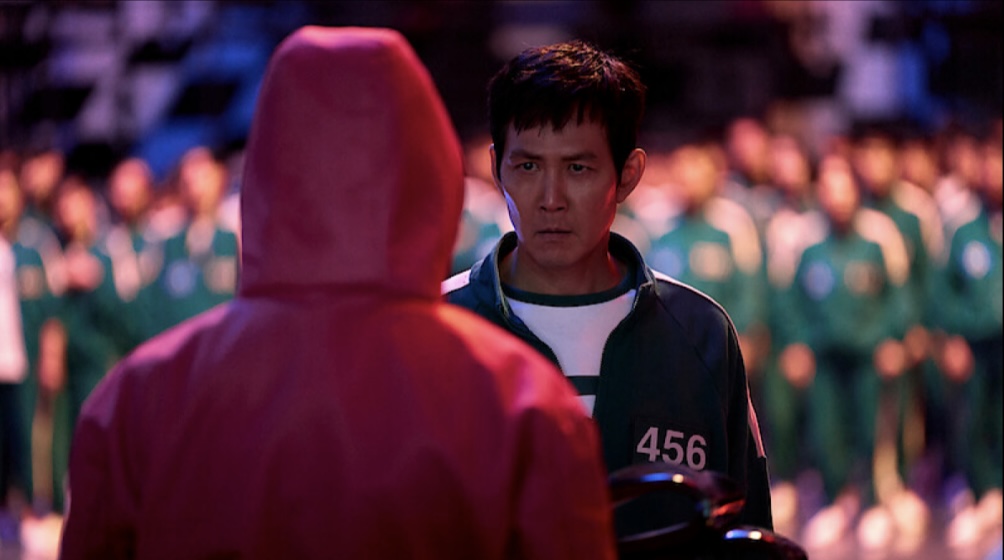 Lee Jung Jae (Gi Hun) attempts to end the games by majority vote after the first game in episode three, but falls short of one vote. Adversities between players begin to stir up after this first vote, and Gi Hun tries to make it out alive with his alliance. Photo courtesy of Netflix.