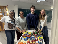 From left to right: seniors Tajiyah Manual, Marlie Smith, Thomas Dillard and junior Anna Daubenspeck hand out breakfast to teachers with the snack cart. Morning breakfast comes around on the first day of the new semester to thank teachers for being outstanding. Photo taken by Fara Wiles.
