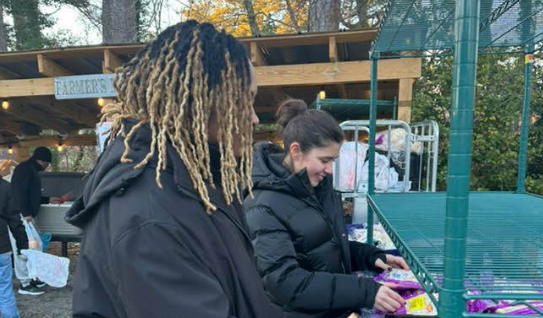 Nyzier Gary-Privott (left) and Nilufer Karahan (right) package food for an Interact service project at Eastern Shore Chapel Episcopal Church. The service project occurred in two sessions, and the first date was on Jan. 7, 2025, and the second date was on Jan. 18, 2025. Photo used with permission with permission by Nyzier Gary-Privott.